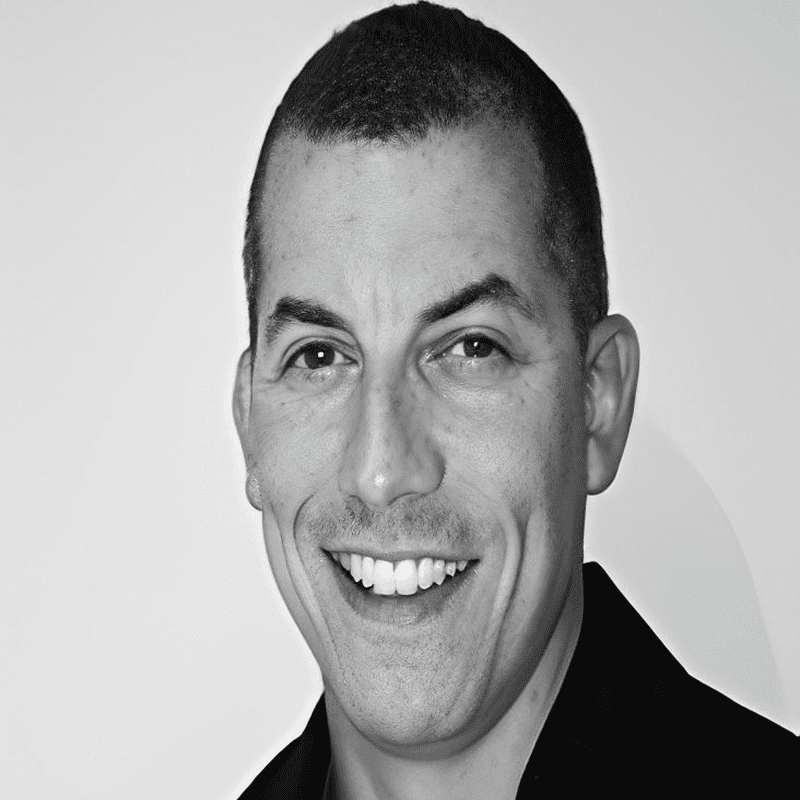 Smiling man headshot, black-and-white photo